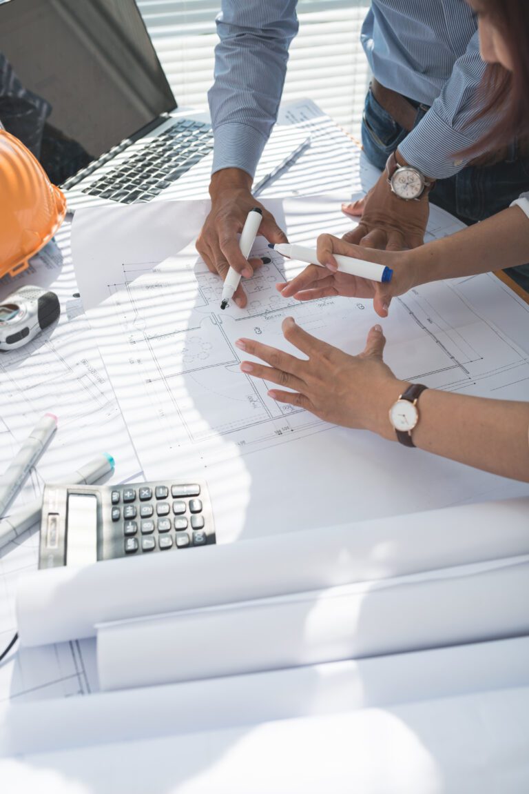 Engineer taking photo of blueprint with invisible smartphone or camera